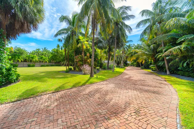 a view of a dining room with furniture large windows and wooden floor
