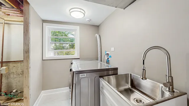 a bathroom with a sink a toilet and a window