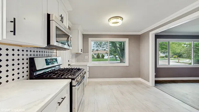 a kitchen with wooden cabinets and a stove top oven