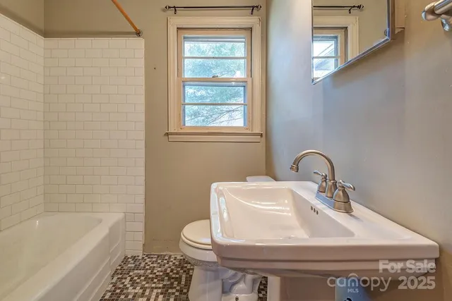 a bathroom with a sink a toilet and bathtub