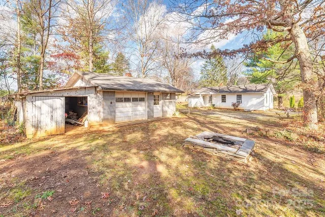 a view of a house with a yard covered with snow and trees