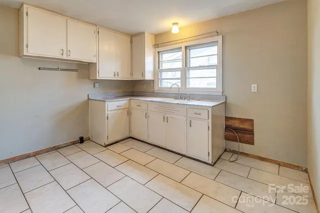 a kitchen with a sink cabinets and window