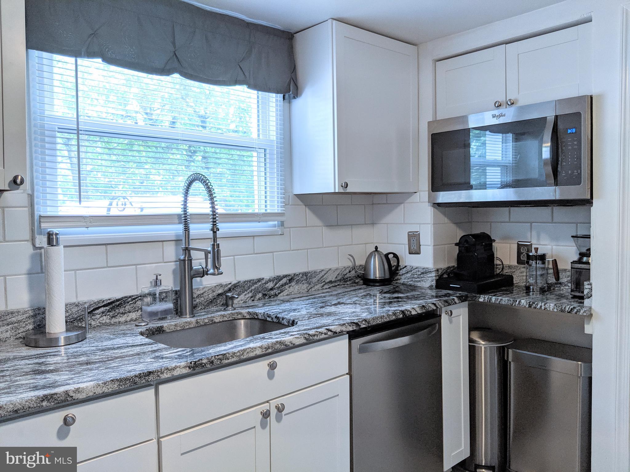 2795 York Rd. Jamison, PA 18929 - Photo 22 of 39 a kitchen with stainless steel appliances granite countertop a sink a stove and a granite counter tops with a window