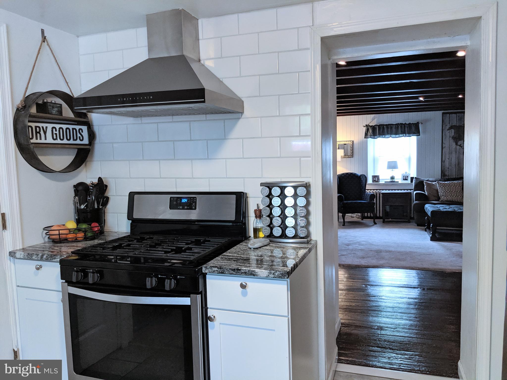 2795 York Rd. Jamison, PA 18929 - Photo 27 of 39 a kitchen with granite countertop a stove and a wooden floors