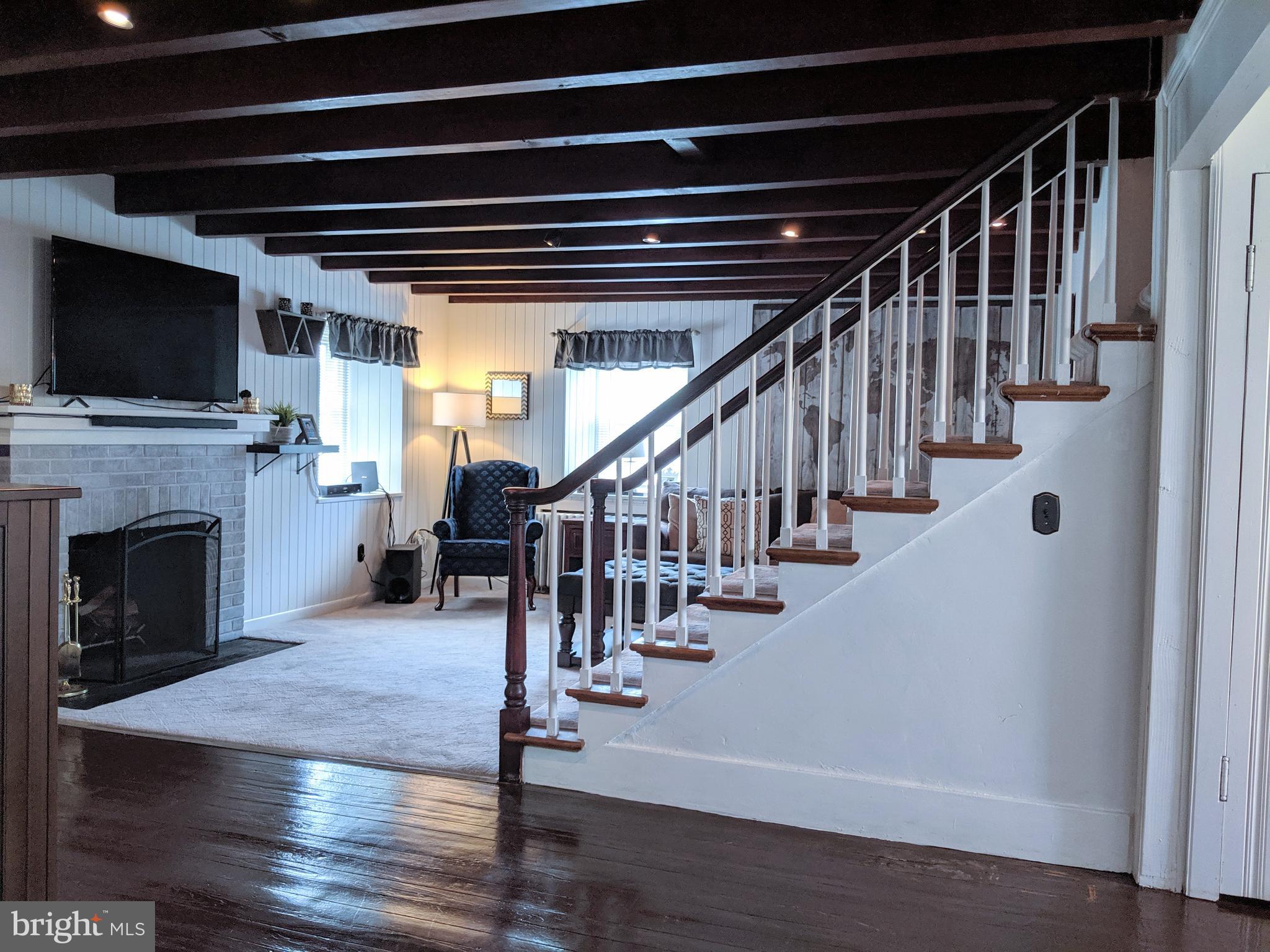 2795 York Rd. Jamison, PA 18929 - Photo 6 of 39 a view of an empty room with wooden floor a fireplace and a window