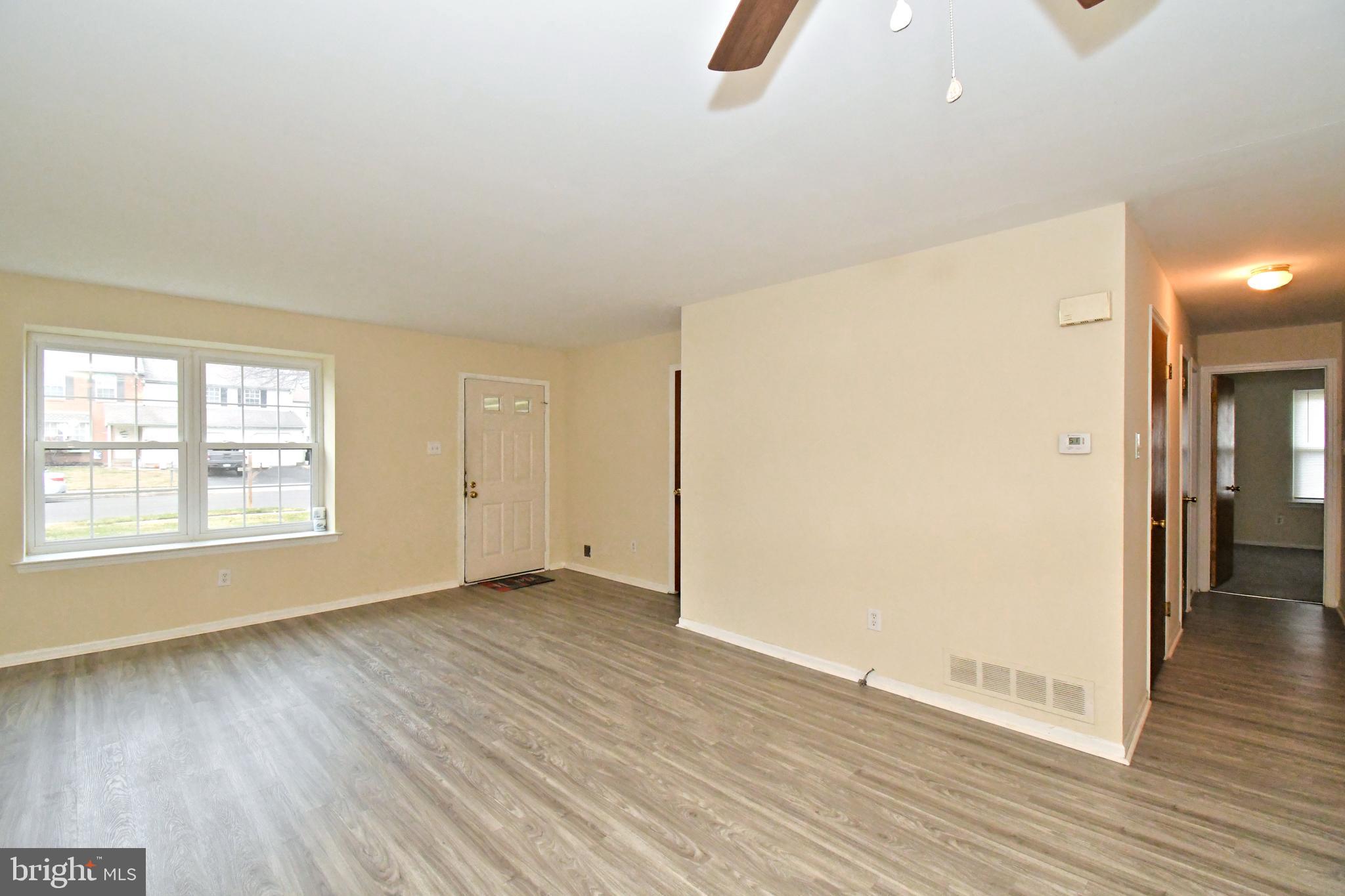 592 A Wrensong Road, Unit A Yardley, PA 19067 - Photo 3 of 36 an empty room with wooden floor and windows
