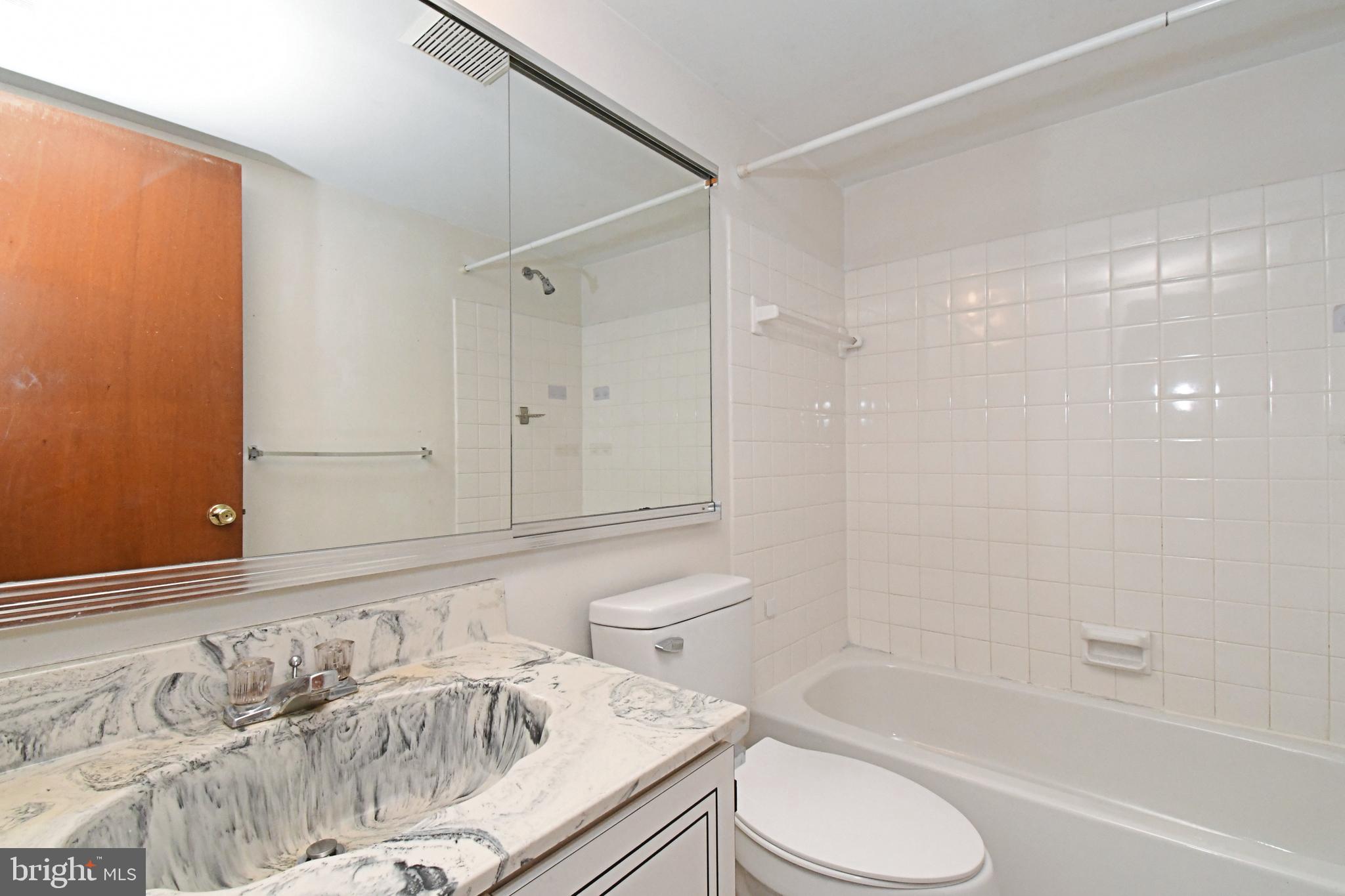 592 A Wrensong Road, Unit A Yardley, PA 19067 - Photo 36 of 36 a bathroom with a granite countertop sink toilet and shower