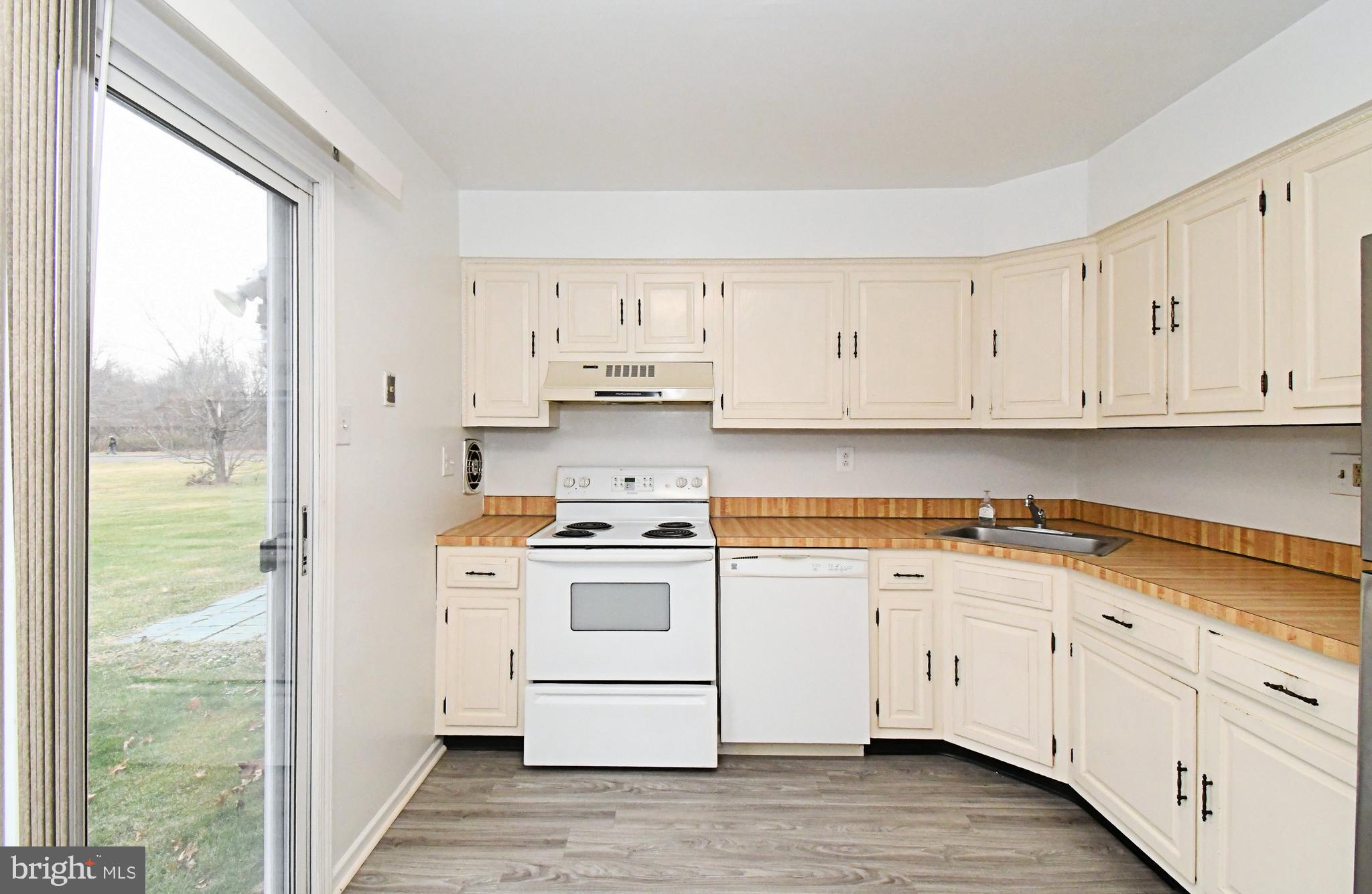 592 A Wrensong Road, Unit A Yardley, PA 19067 - Photo 6 of 36 a kitchen with cabinets appliances a sink and a window