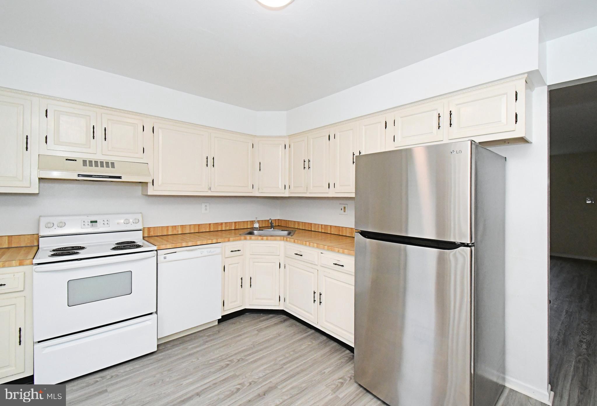 592 A Wrensong Road, Unit A Yardley, PA 19067 - Photo 7 of 36 a white refrigerator freezer sitting in a kitchen