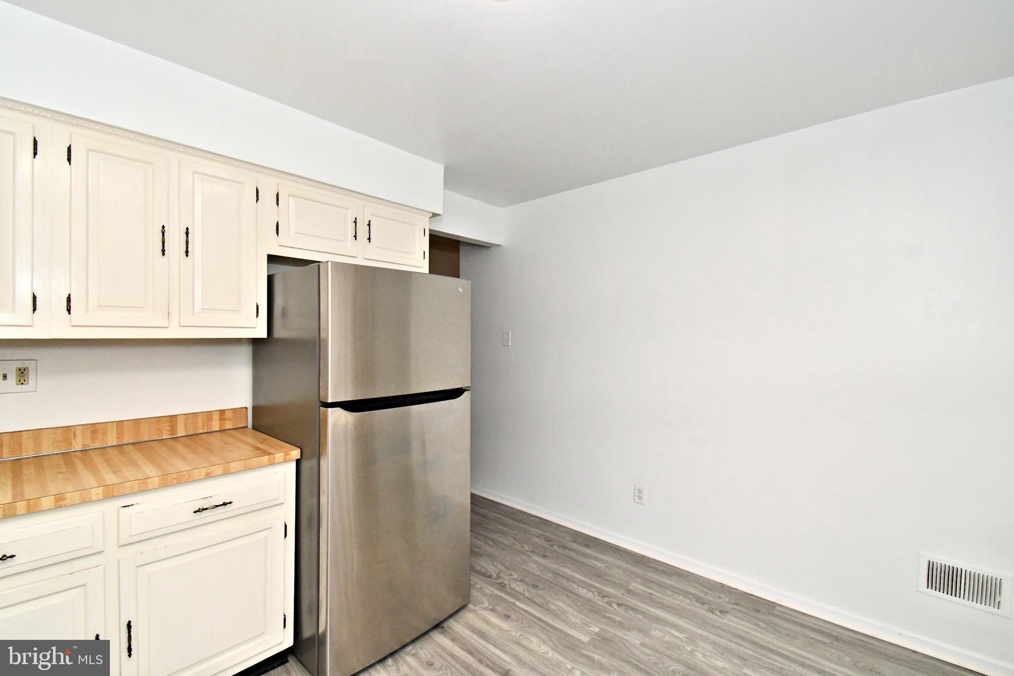 592 A Wrensong Road, Unit A Yardley, PA 19067 - Photo 9 of 36 a white refrigerator freezer sitting in a kitchen