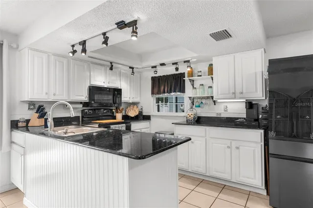 a stove top oven sitting inside of a kitchen