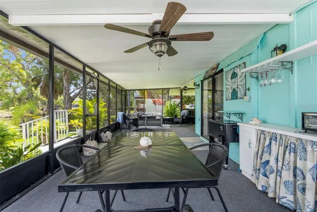a roof deck view with table and chairs potted plants and palm trees