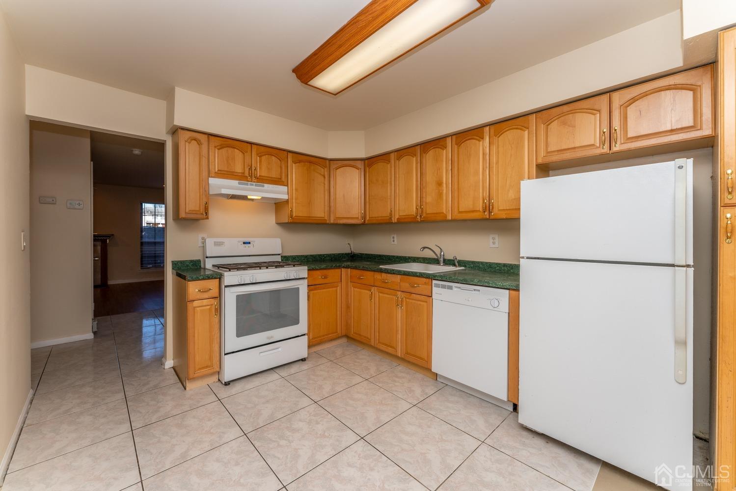 3204 Stonehedge Road Edison, NJ 08820 - Photo 11 of 22 a kitchen with a refrigerator sink and cabinets