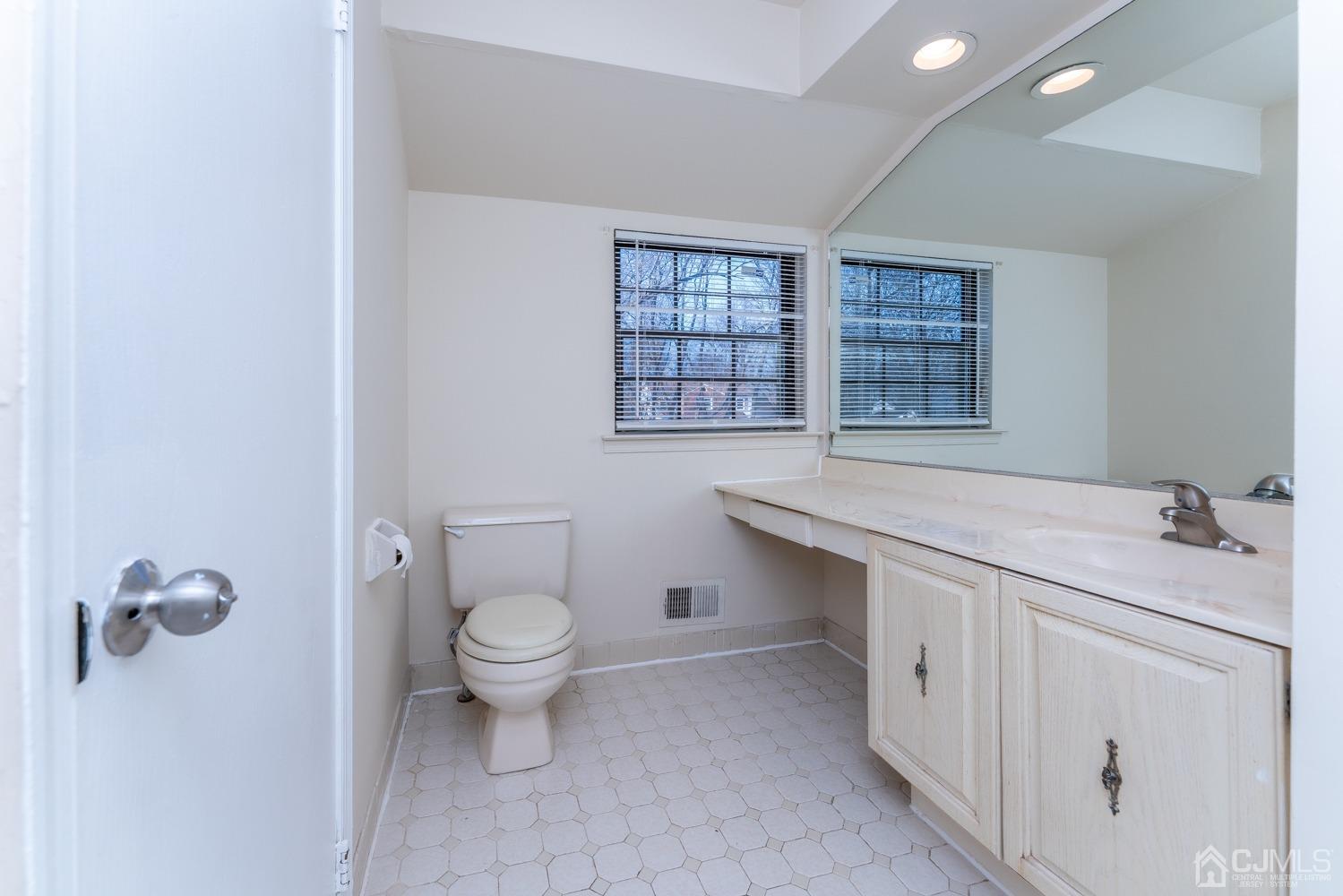 3204 Stonehedge Road Edison, NJ 08820 - Photo 12 of 22 a bathroom with a toilet sink and window