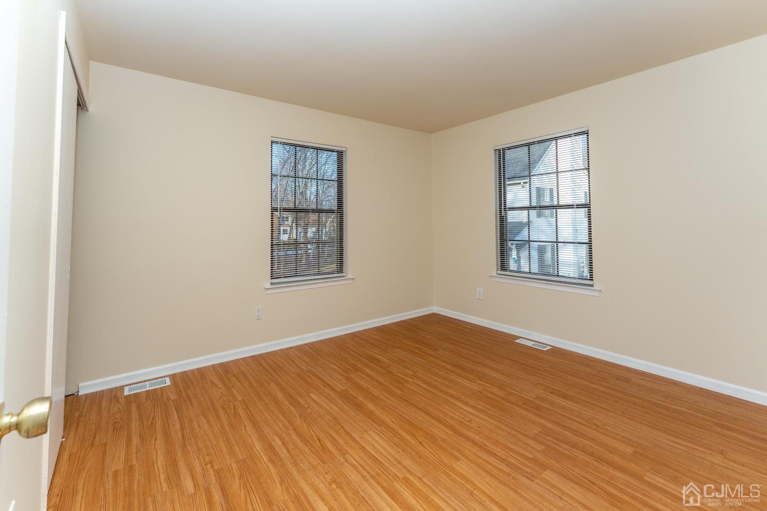 3204 Stonehedge Road Edison, NJ 08820 - Photo 18 of 22 an empty room with wooden floor closet and windows