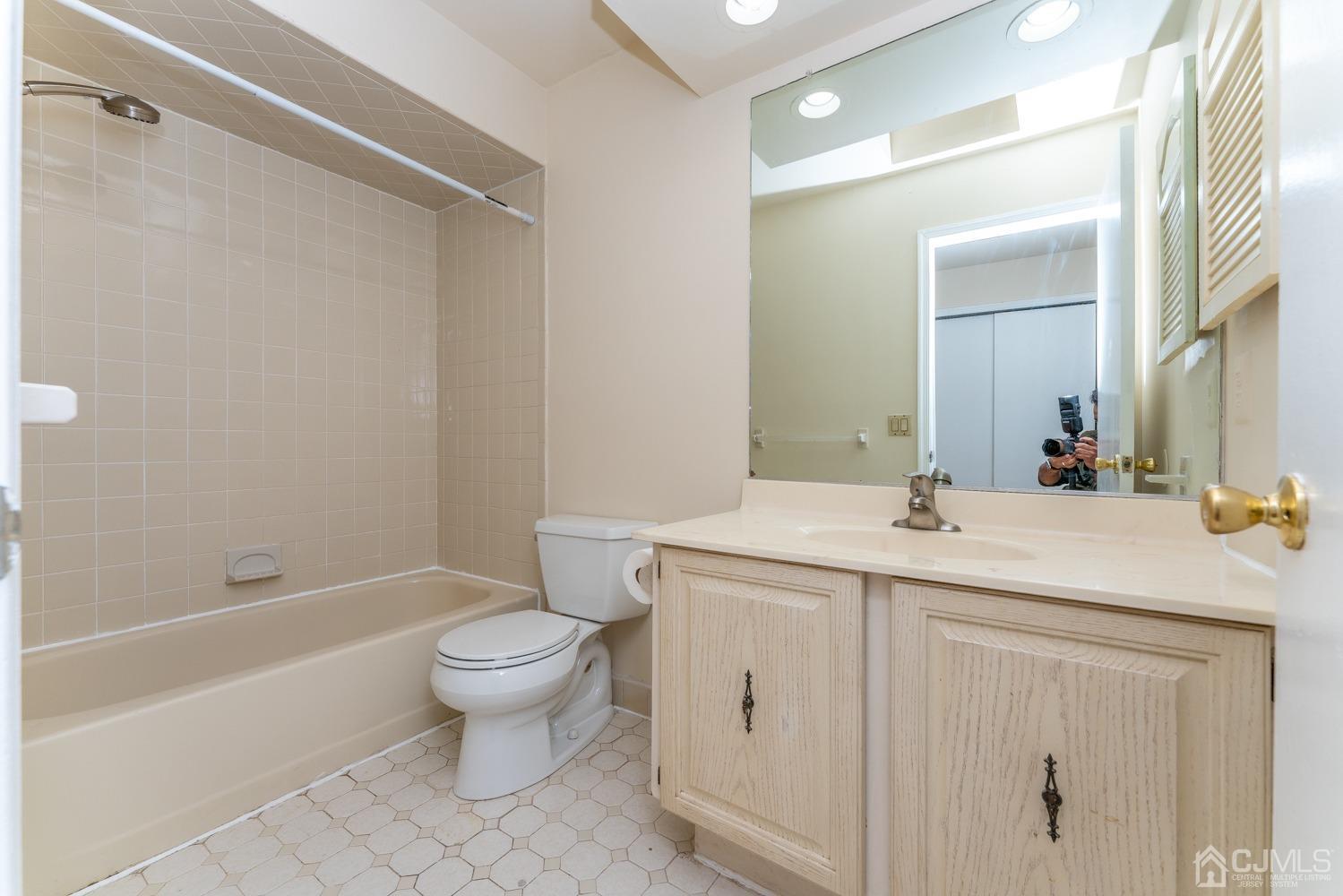 3204 Stonehedge Road Edison, NJ 08820 - Photo 19 of 22 a bathroom with a sink toilet vanity and shower