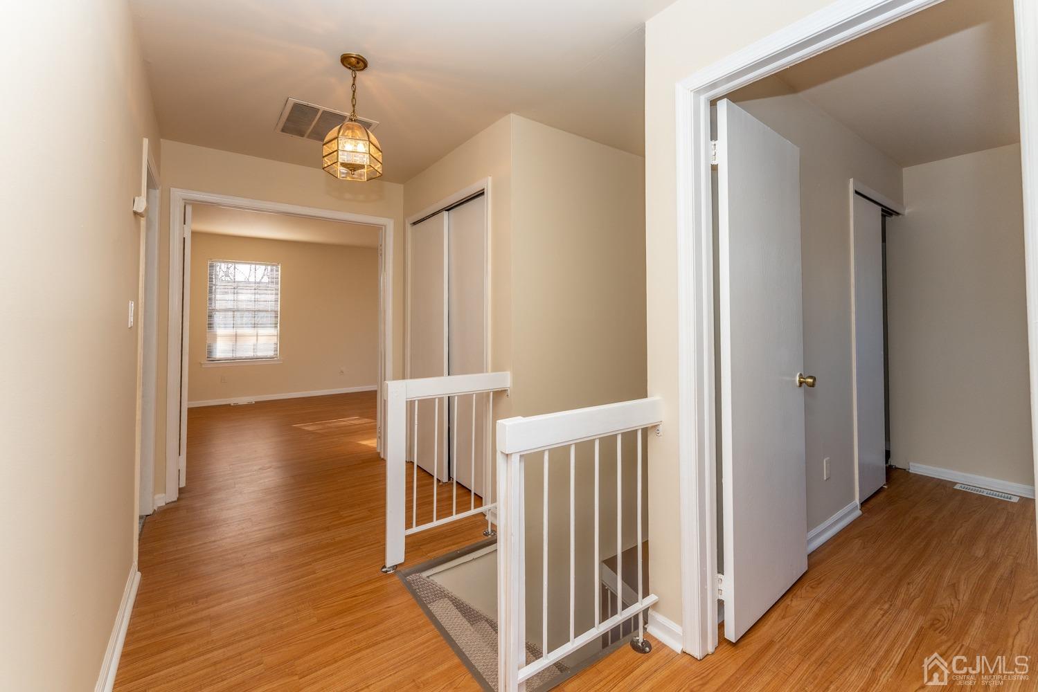 3204 Stonehedge Road Edison, NJ 08820 - Photo 22 of 22 a view of a hallway with wooden floor and stairs