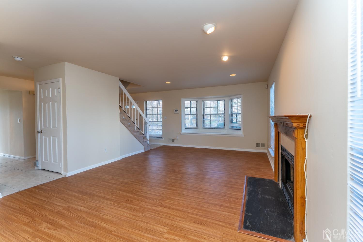 3204 Stonehedge Road Edison, NJ 08820 - Photo 8 of 22 a view of livingroom with hardwood floor and hallway