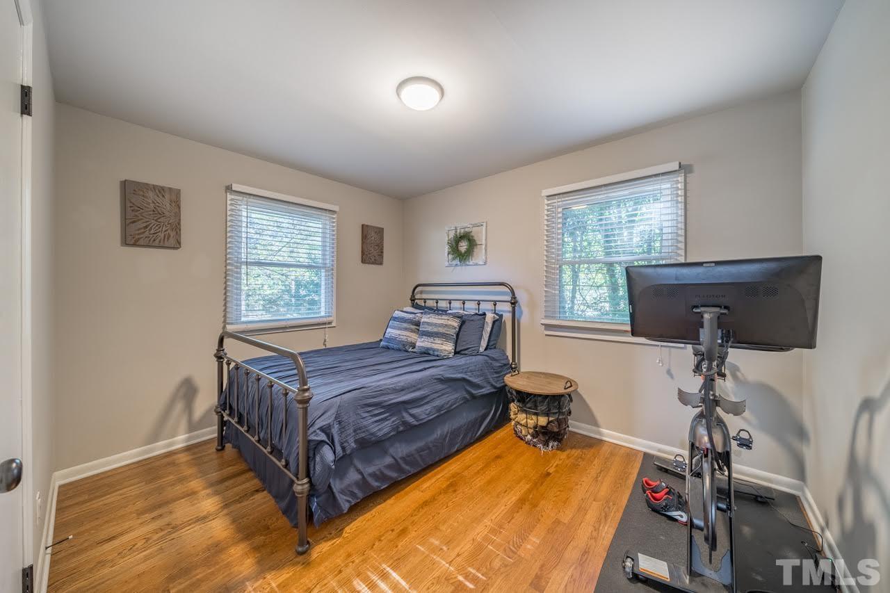1105 Somerset Road Raleigh, NC 27610 - Photo 14 of 19 a bedroom with a bed and windows