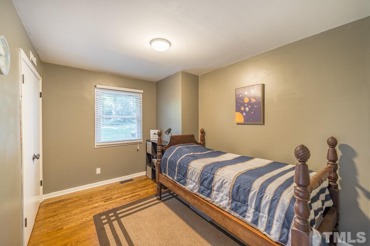 1105 Somerset Road Raleigh, NC 27610 - Photo 15 of 19 a bedroom with a bed and a window