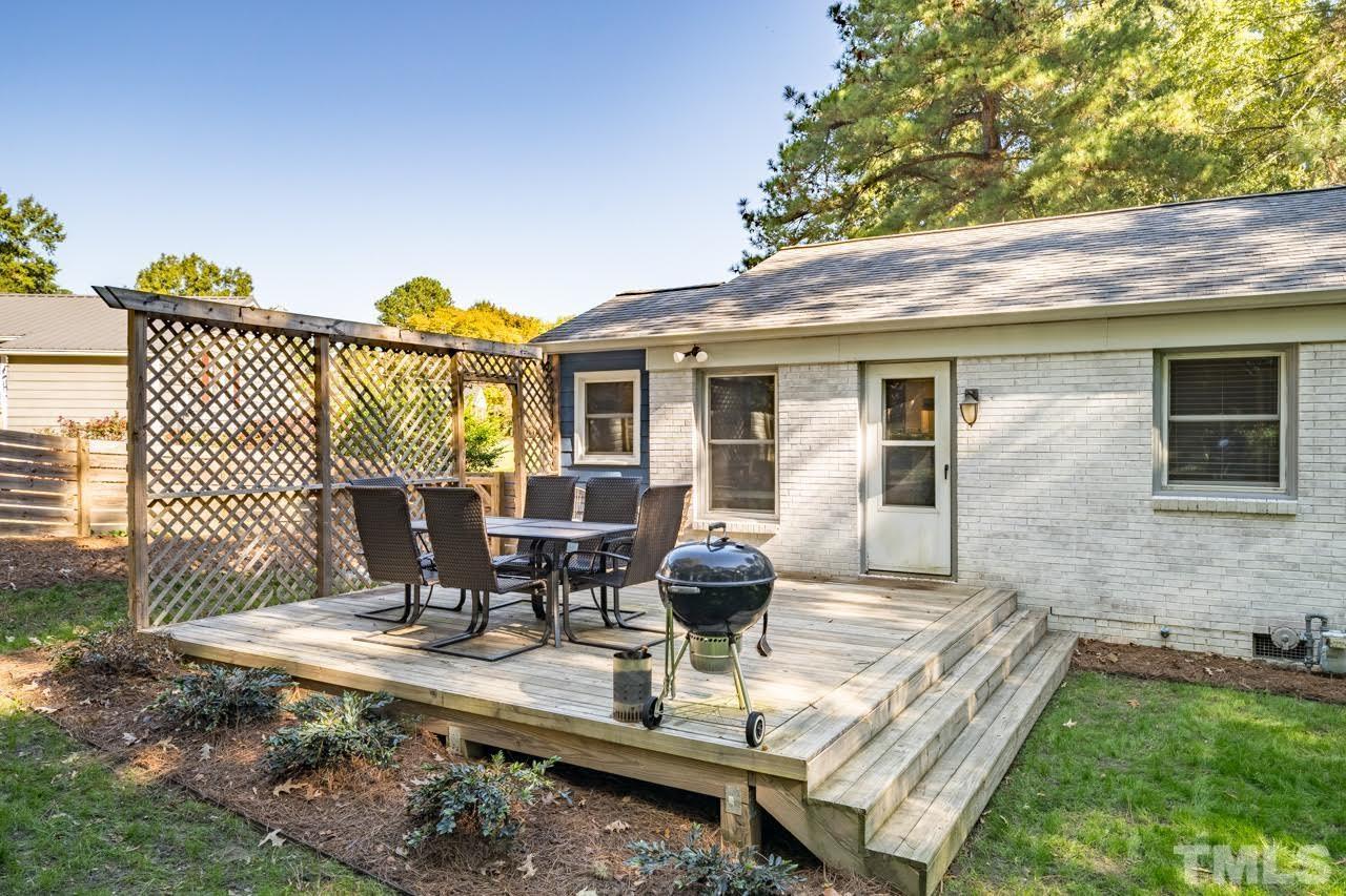 1105 Somerset Road Raleigh, NC 27610 - Photo 18 of 19 a view of a house with backyard sitting area and garden