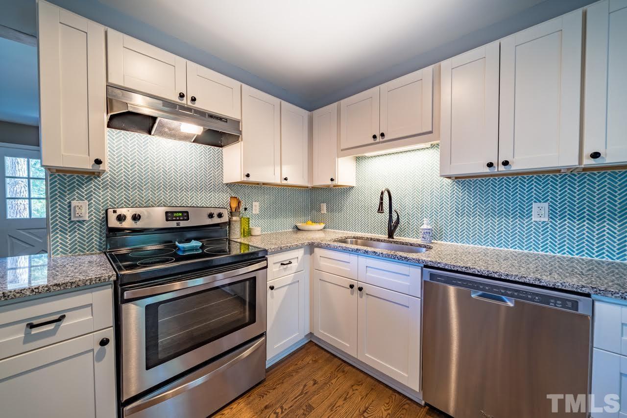 1105 Somerset Road Raleigh, NC 27610 - Photo 7 of 19 a kitchen with granite countertop a stove sink and cabinets