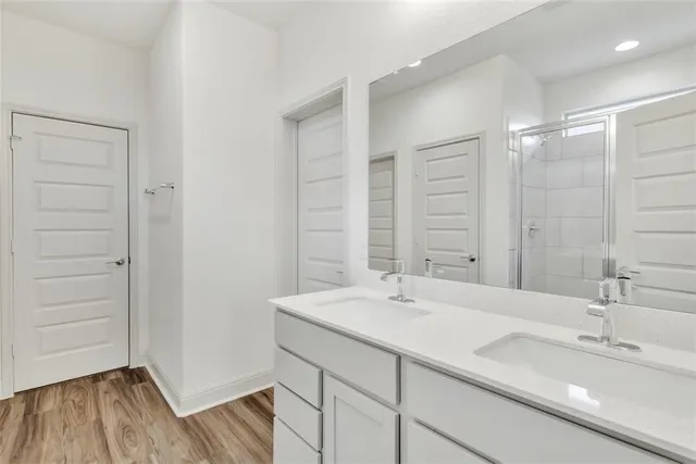 a bathroom with a double vanity sink and a mirror