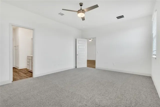 a view of an empty room with a ceiling fan