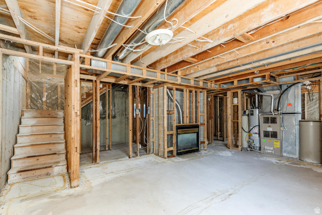342 East 600 North Logan, UT 84321 - Photo 12 of 23 Unfinished lower level featuring exposed wood framing, concrete flooring, and a built-in fireplace insert