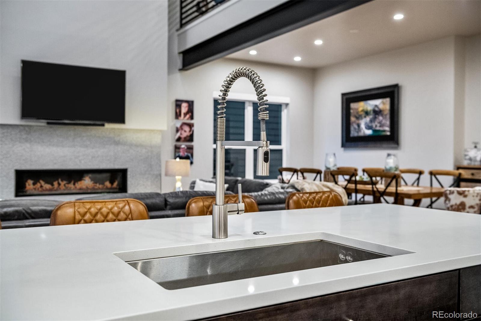 10109 Bellwether Lane Lone Tree, CO 80124 - Photo 12 of 40 a view of living room kitchen with stainless steel appliances cabinets and fireplace