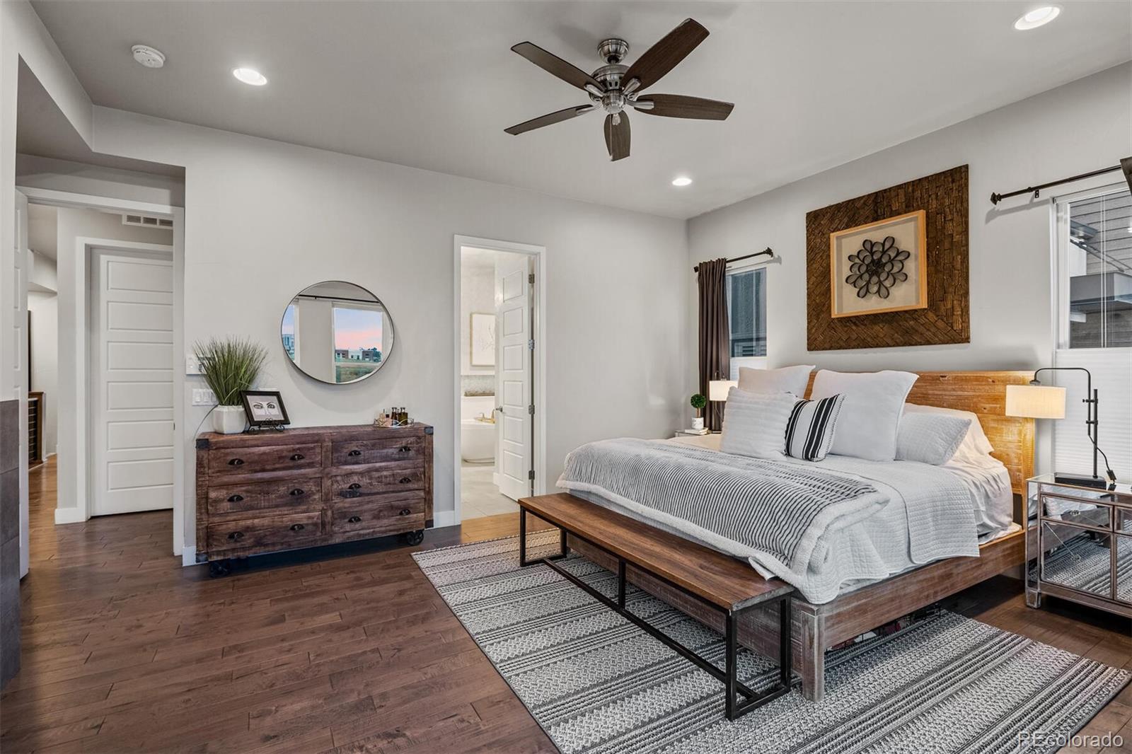 10109 Bellwether Lane Lone Tree, CO 80124 - Photo 18 of 40 a bedroom with a bed and wooden floor