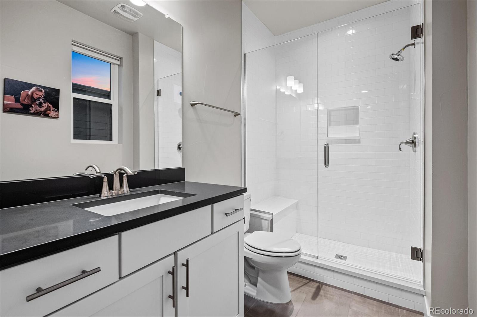 10109 Bellwether Lane Lone Tree, CO 80124 - Photo 27 of 40 a bathroom with a granite countertop sink a toilet and shower