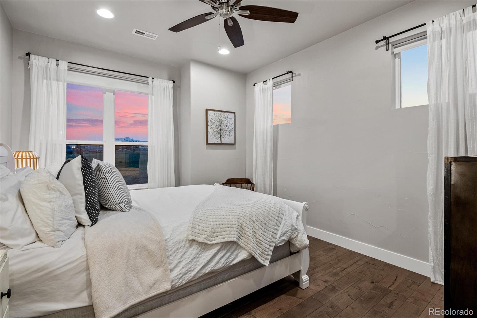 10109 Bellwether Lane Lone Tree, CO 80124 - Photo 28 of 40 a bedroom with a bed flat screen tv and a large window