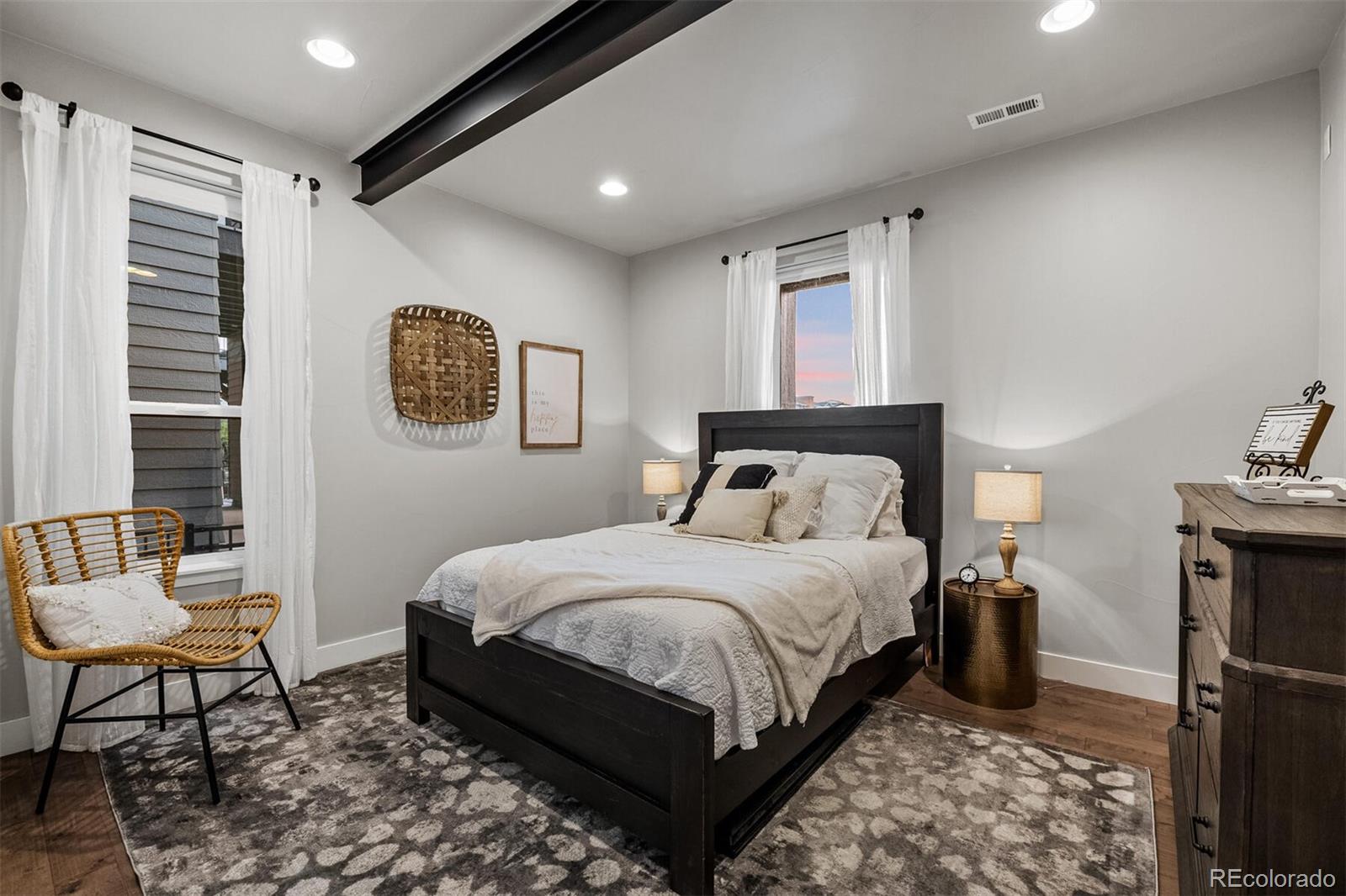 10109 Bellwether Lane Lone Tree, CO 80124 - Photo 31 of 40 a bedroom with a bed a chair and potted plant