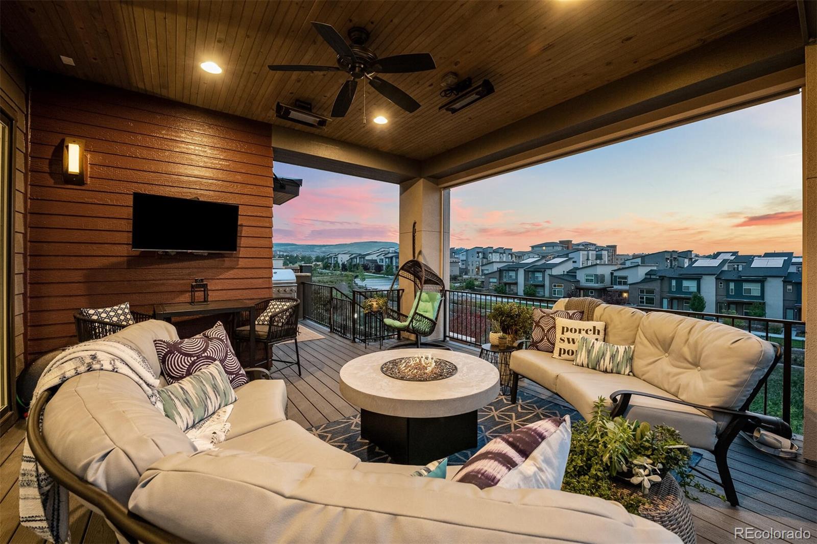 10109 Bellwether Lane Lone Tree, CO 80124 - Photo 32 of 40 a view of a patio with couches chairs and a fire pit