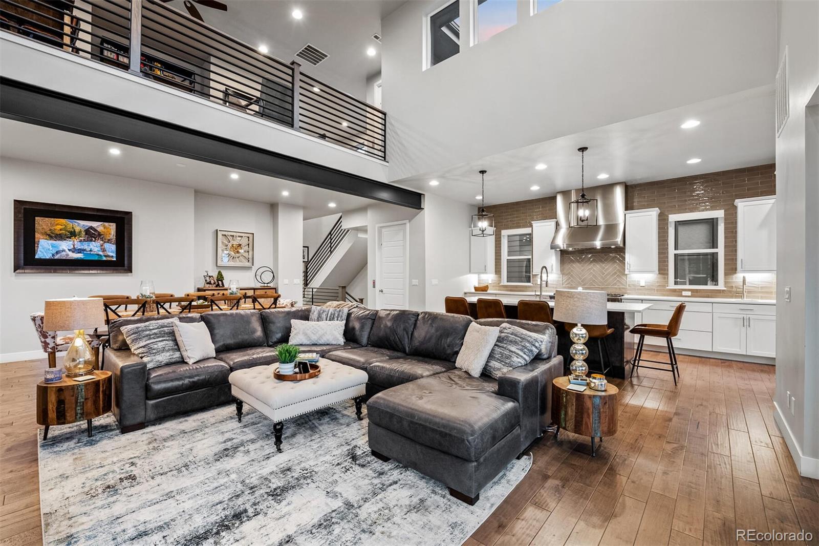 10109 Bellwether Lane Lone Tree, CO 80124 - Photo 6 of 40 a living room with furniture kitchen view and a wooden floor