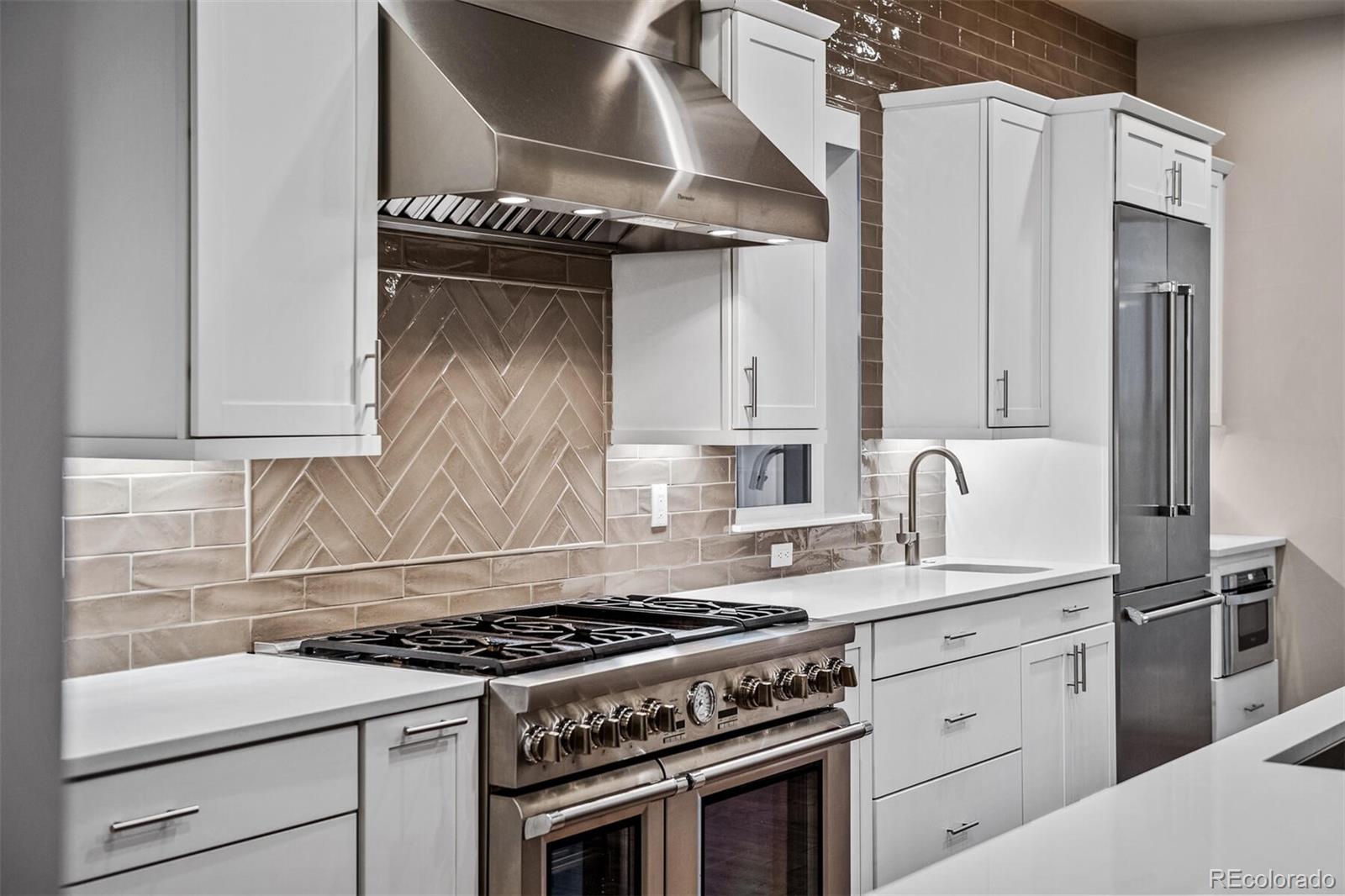 10109 Bellwether Lane Lone Tree, CO 80124 - Photo 7 of 40 a white stove top oven sitting inside of a kitchen