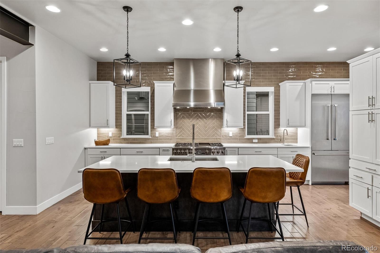 10109 Bellwether Lane Lone Tree, CO 80124 - Photo 9 of 40 a kitchen with a dining table chairs and wooden floor