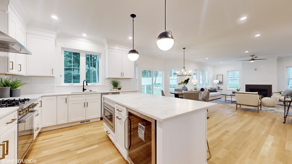 49 Ledge Hill Road Boston, MA 02132 - Photo 11 of 34 a large kitchen with kitchen island a stove a sink a center island and windows