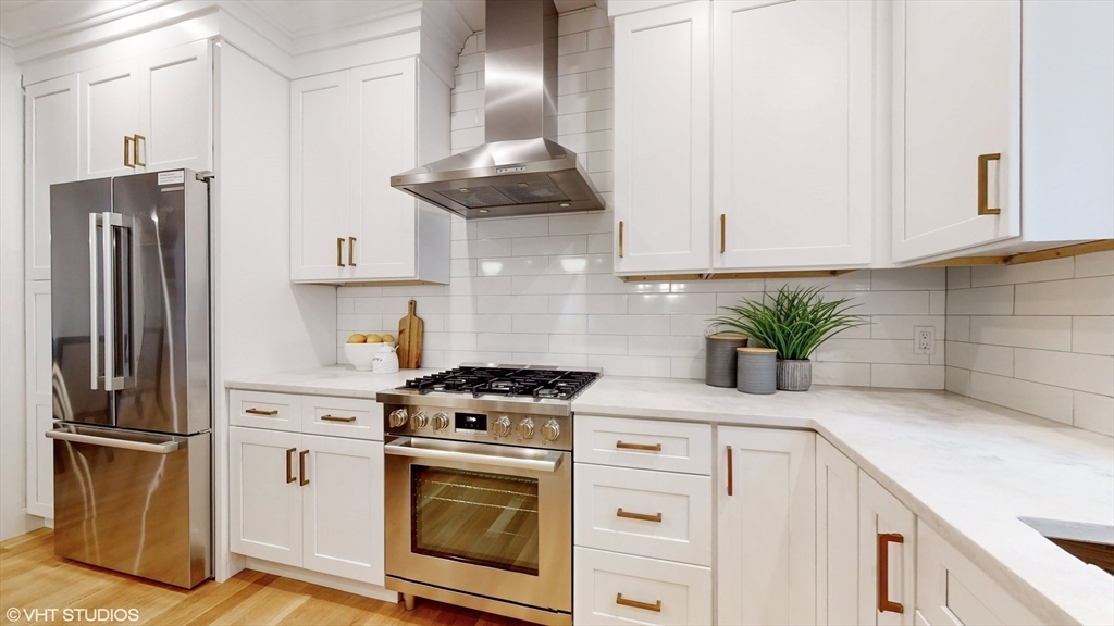 49 Ledge Hill Road Boston, MA 02132 - Photo 12 of 34 a kitchen with granite countertop a stove a refrigerator and a sink