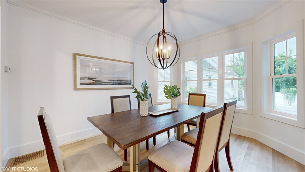 49 Ledge Hill Road Boston, MA 02132 - Photo 15 of 34 a view of a dining room with furniture a chandelier and wooden floor