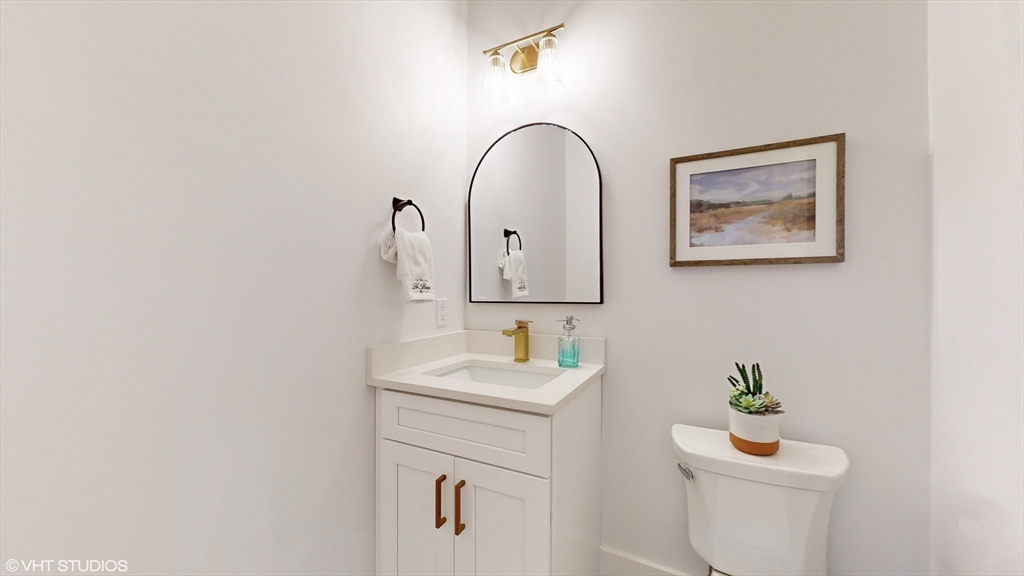 49 Ledge Hill Road Boston, MA 02132 - Photo 16 of 34 a bathroom with a toilet sink and mirror