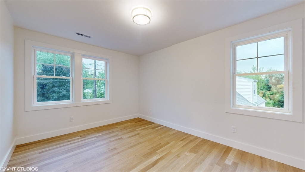 49 Ledge Hill Road Boston, MA 02132 - Photo 23 of 34 an empty room with wooden floor and windows