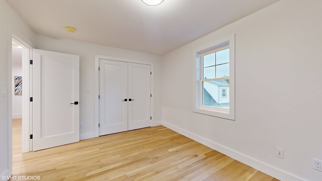 49 Ledge Hill Road Boston, MA 02132 - Photo 25 of 34 a view of empty room with window and wooden floor