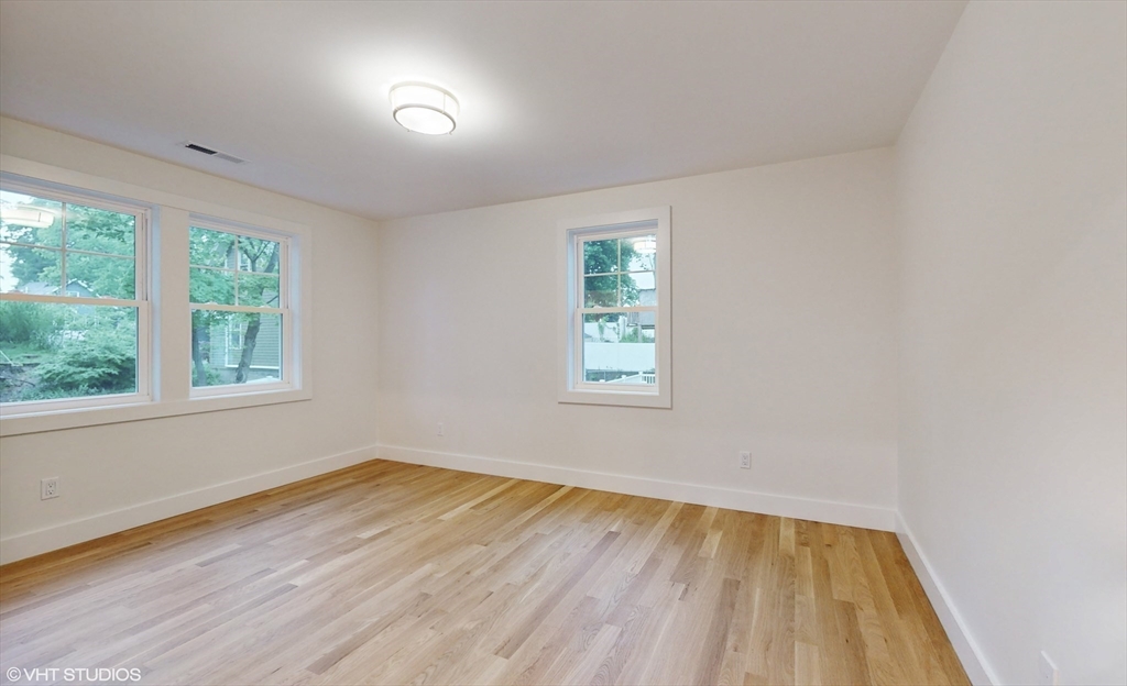 49 Ledge Hill Road Boston, MA 02132 - Photo 27 of 34 an empty room with a hardwood and windows