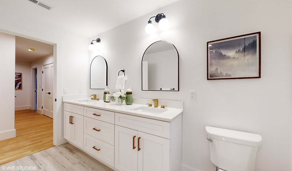 49 Ledge Hill Road Boston, MA 02132 - Photo 28 of 34 a spacious bathroom with 2 sink bathtub and a toilet