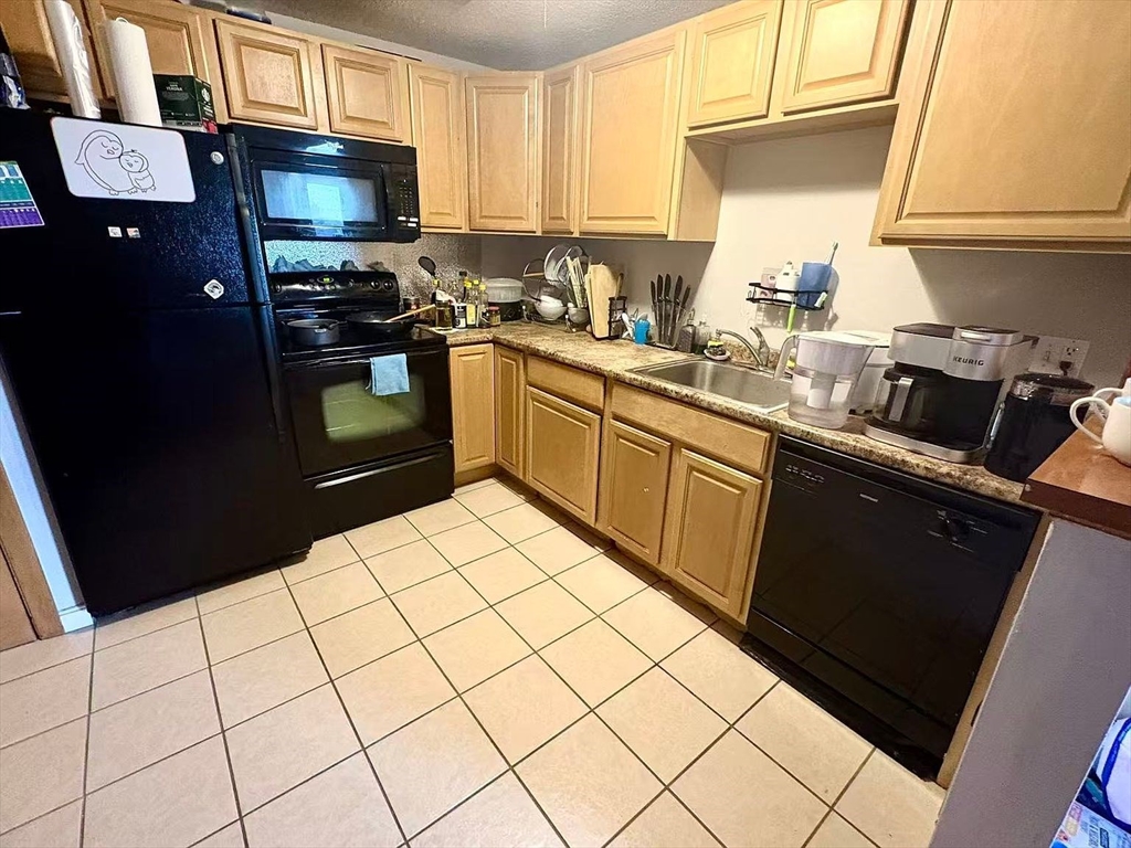 80 Main Street, Unit 26 Malden, MA 02148 - Photo 3 of 8 a kitchen with stainless steel appliances a sink stove refrigerator and cabinets