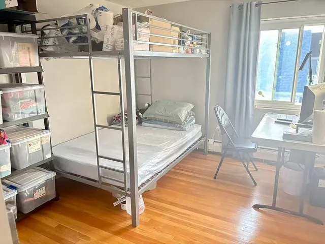 a spacious bedroom with a bed and a table