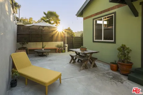 a yellow and white house with a clock on the wall