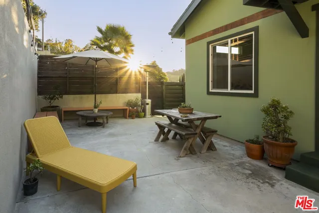 a yellow and white house with a clock on the wall